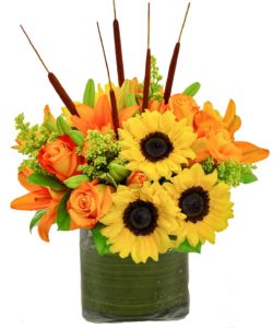 sunflowers orange roses and orange lilies with green accents in vase