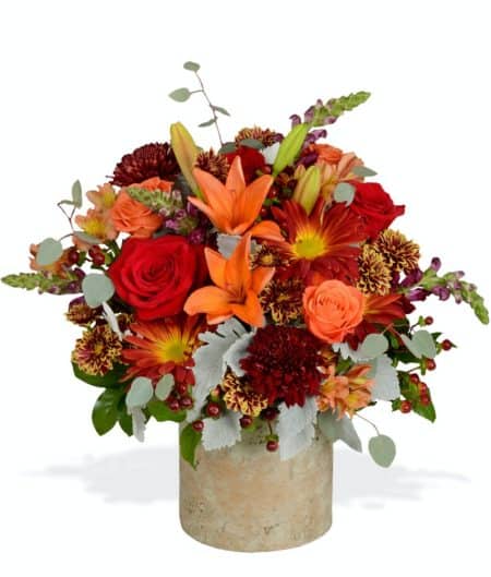 Warm your home with a beautiful fall flower arrangement full of cheer! Perfect as a Thanksgiving centerpiece or autumn statement arrangement, this design will add fall hues wherever placed.